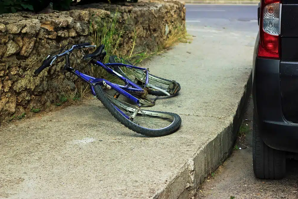 Bicycle with bent tires on sidewalk